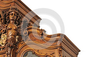 A fragment of an ancient carved furniture closeup isolated on a