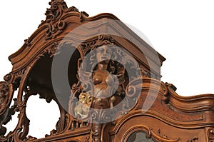A fragment of an ancient carved furniture closeup isolated on a wiht background