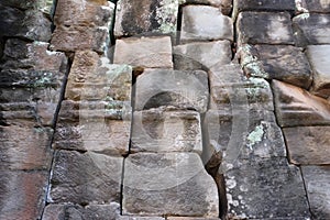 Fragment of the ancient stone wall, decorated with carvings. Medieval stonework. Background