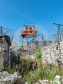Fragment of barbed wire mounted above prison fence,