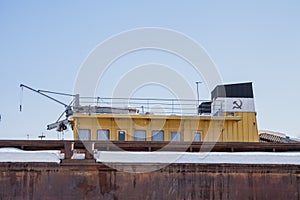 Fragment of a barge with a captain`s cabin in a winter parking