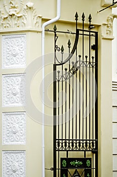 A fragment of a beautiful wrought-iron gate. Vertical photography