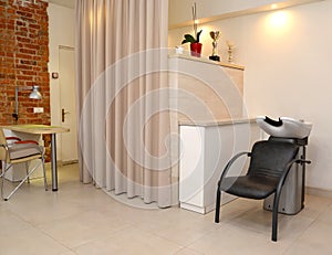 Fragment of beauty salon with hairdresser `s wash and attachment table