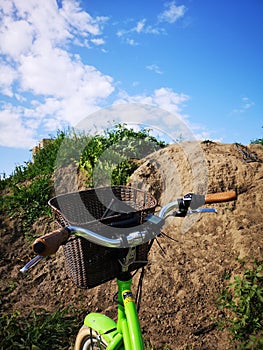 a fragment of a bicycle on the background of the sky and a hill