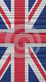 Fragment of British flag on a dry wooden surface. Natural vertical background. Mobile phone wallpaper made of old wood. The