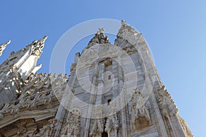 Fragment of the cathedral in Milan, Italy in summer against the blue sky