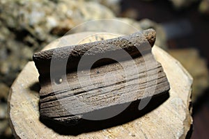 Fragment of a ceramic vessel with a rim found at a medieval archaeological site