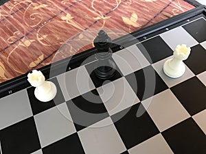 Fragment of chess party. figures are on the board. mat put black King