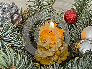 Fragment of a Christmas decoration with a candle and an angel