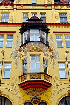 Fragment of a colorful facade with a beautiful bay window in the historical center of Prague