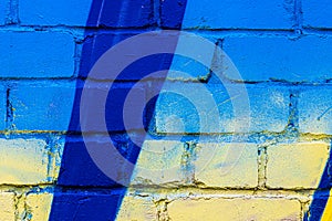 A fragment of colorful graffiti painted on a brick wall. Abstract backdrop for design