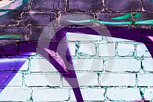 A fragment of colorful graffiti painted on a brick wall. Abstract backdrop for design