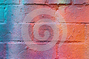 A fragment of colorful graffiti painted on a brick wall. Abstract backdrop for design