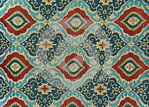 Fragment of colorful retro tapestry textile pattern with floral ornament useful as background