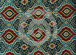 Fragment of colorful retro tapestry textile pattern with floral ornament useful as background