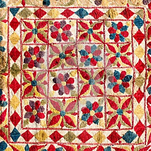 Fragment of colorful retro tapestry textile pattern with handmade floral ornament as background.