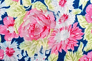 Fragment of colorful retro tapestry textile pattern with handmade floral ornament as background.