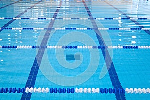 Fragment of the competition pool with blue water and marked swimming lanes