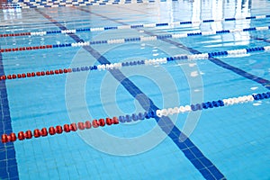 Fragment of the competition pool with blue water and marked swimming lanes