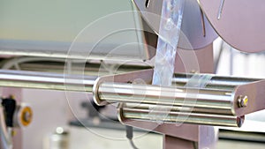 Fragment of the conveyor of sticking labeling packaging machine.