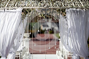 Fragment of creatively decorated wedding arch outdoors