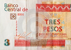 Fragment of crumpled cuban banknote of orange three pesos convertibles 2016