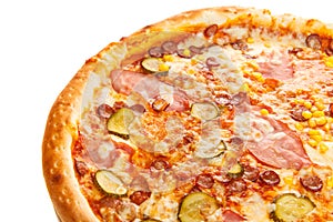 Fragment of delicious classic italian pizza with ham, sausages, corn, cucumbers and cheese