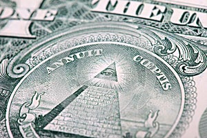 Fragment of a dollar bill. eye and pyramid closeup