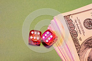 A fragment of a dollar on the table next to the dice.