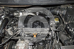 A fragment of the engine compartment of a car with a three-cylinder diesel engine