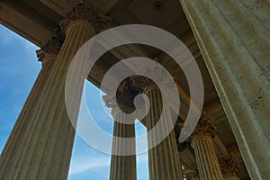 Fragment of the facade of the building with columns, Historic building against the sky