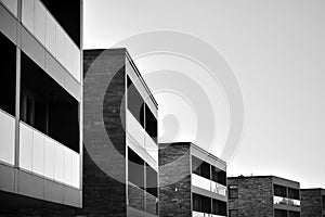 Fragment of a facade of a building with windows and balconies. Black and white.