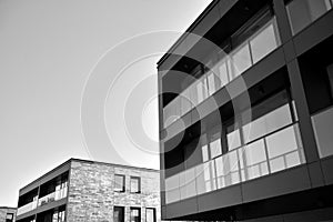 Fragment of a facade of a building with windows and balconies. Black and white.