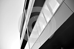 Fragment of a facade of a building with windows and balconies. Black and white.