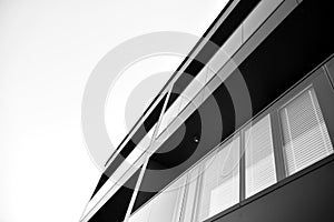 Fragment of a facade of a building with windows and balconies. Black and white.