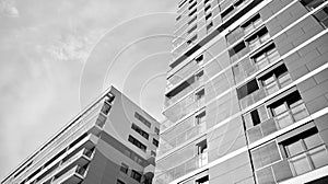 Fragment of a facade of a building with windows and balconies. Black and white.