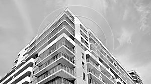 Fragment of a facade of a building with windows and balconies. Black and white.