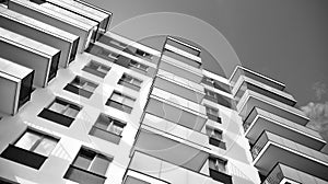 Fragment of a facade of a building with windows and balconies. Black and white.