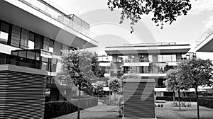 Fragment of a facade of a building with windows and balconies. Black and white.