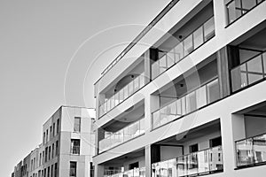 Fragment of a facade of a building with windows and balconies. Black and white.