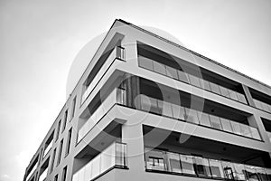 Fragment of a facade of a building with windows and balconies. Black and white.