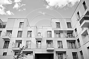 Fragment of a facade of a building with windows and balconies. Black and white.