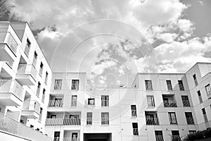 Fragment of a facade of a building with windows and balconies. Black and white.