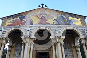 Fragment of the facade of the Church of All Nations with colorful mosaics on the portico