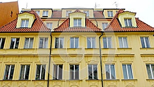 Fragment of the facade of a house with dormer windows