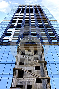 A fragment of the facade of a house under construction, a modern building is being built, the view is directed upwards.