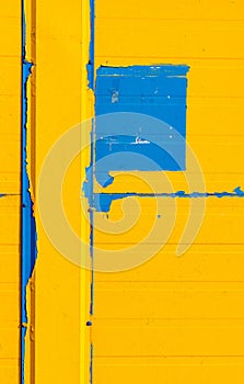 Fragment of the facade painted with yellow-blue paint.