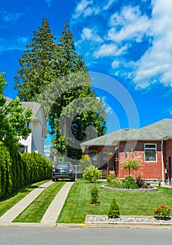 Fragment of a family house with traced driveway and parked car on it