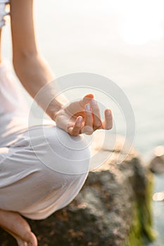 Fragment of female hand practicing yoga gyan mudra position