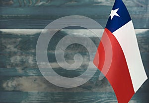 Fragment of the flag of the Republic of Chile in the foreground blurred light background copy space
